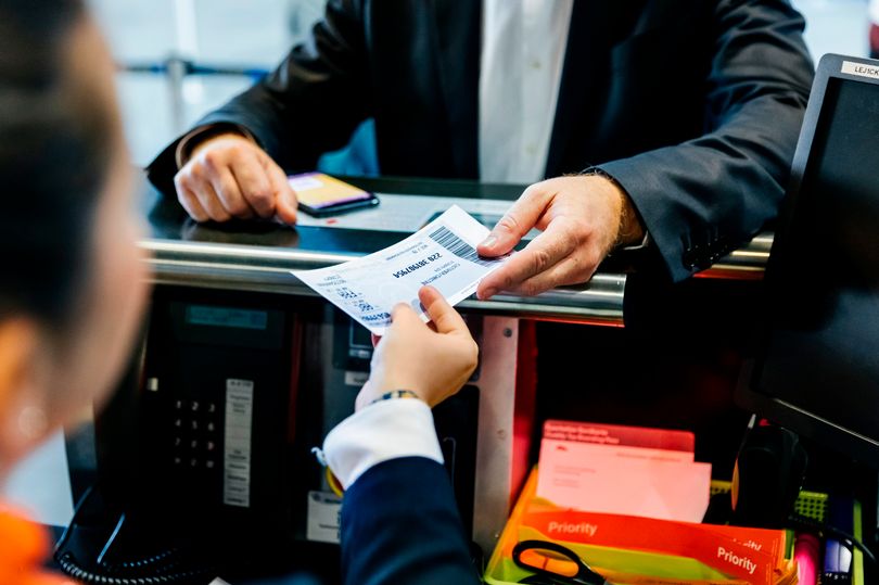 sman-getting-his-boarding-pass-at-check-in-counter.jpg